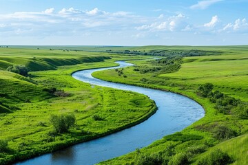 Sticker - A serene scene of a river flowing peacefully through a lush green field