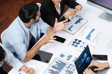 Canvas Print - Analyst team utilizing BI Fintech to analyze financial data at table in meeting room. Businesspeople analyzing BI dashboard power on paper for business insight and strategic marketing planning.Prudent