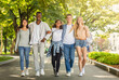 © Prostock-studio - Carefree multiracial students walking together by public park after university