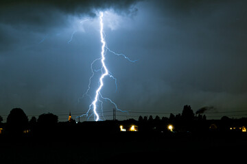tele photo of a distant branched lightning bolt at night, more than 50 kilometers away