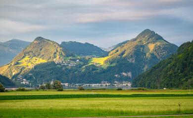 Wall Mural - mountain peaks near lake lucerne, switzerland are illuminated by the low sun