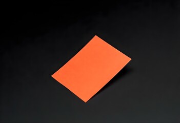 a single blank color post-it note in bright orange isolated on a smooth black surface create with ai