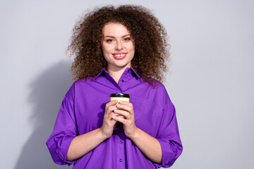 Wall Mural - Portrait of pretty young woman hold coffee empty space wear violet shirt isolated on grey color background