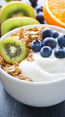 Wall Mural - This bowl features granola generously topped with blueberries, slices of kiwi, and oranges, perfectly arranged against a rich wooden background for a refreshing breakfast option