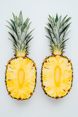 Two halved pineapples on a light background, perfect for summer recipes, health food promotions, and tropical-themed designs.