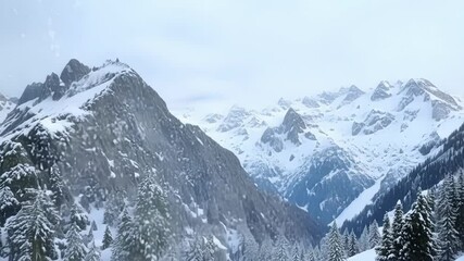 Aufkleber - Snow falls on a vast mountain range with pine trees, creating a serene winter scene