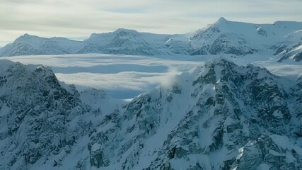 Aufkleber - Large avalanche of fresh powder cascades down a rugged mountainside, leaving a trail of white against the dark rock, in a stunning display of nature's power