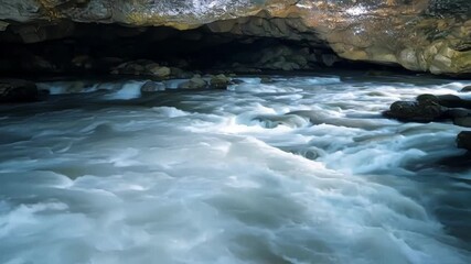 Poster - Rushing river rapids flow through dark cave, creating mesmerizing spectacle. Water carves through rock formations, showcasing stunning scenery. Perfect for adventure seekers in wilderness
