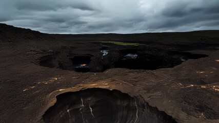 Poster - Showing the powerful forces that shape our planet, a landscape of volcanic origin is dominated by deep craters, a testament to earth's geological activity