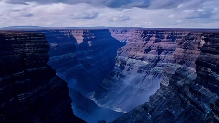 Aufkleber - Immense canyon is stretching across a vast landscape under a cloudy sky, showcasing the awe inspiring power of nature and the beauty of geological formations