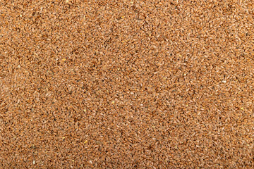 Brown flax seeds layered as a background