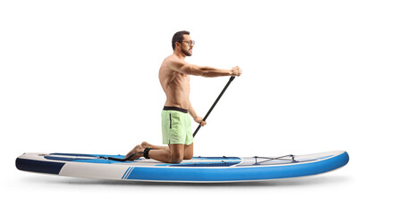 Poster - Full length profile shot of a man paddling a SUP board on knees