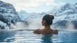 © Viacheslav - A woman enjoys a hot bath in a pool at a spa retreat with steam around her, against a backdrop of snowy mountains in winter.