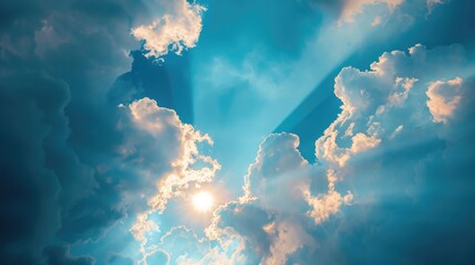 Wall Mural - Sunlight shines through clouds in a clear blue sky