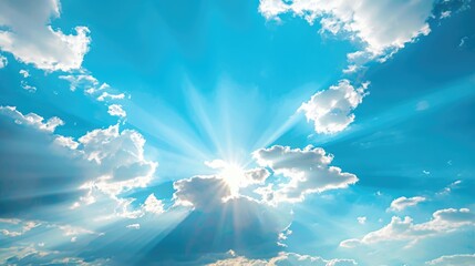 Wall Mural - Sunlight shines through clouds in a clear blue sky