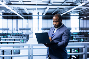 Poster - Software developer in data center implementing backup solutions to protect against data loss using laptop, ensuring efficiency. High tech workspace specialist resolving technical issues using notebook