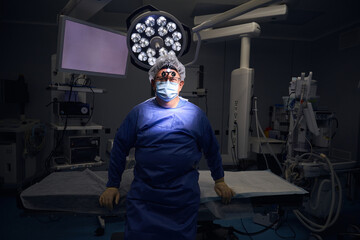 Surgeon looking ahead in a dimly lit operating room