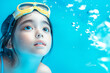 © ChaoticDesignStudio - Young child explores underwater with swimming goggles at pool