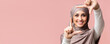 © Prostock-studio - Frame your beauty. Smiling muslim girl in hijab making frame with fingers, capturing moment, posing over pink background with empty space