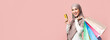 © Prostock-studio - Happy customer. Joyful muslim girl in hijab with colorful shopping bags and credit card over pink studio background and looking at camera, empty space