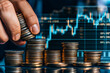 © kongkiat chairat - Hand stacking coins with financial graph in background, representing investment, growth, and economic analysis.