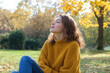 © Aris - French woman wearing yellow knitted sweatshirt in autumn park at sunny day
