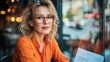 © DigitalMagicVisions - Senior Businesswoman Leading Quarterly Report Review Meeting with Diverse Team in Modern Glass-Walled Office