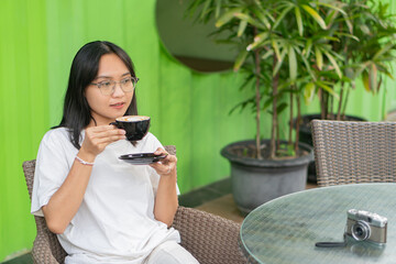 Young Woman Enjoying Coffee at a Cafe