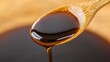 © BOJOShop - Close up of Soy Sauce Dripping from Wooden Spoon