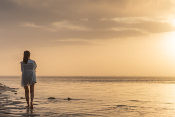 Woman at Sunset on the Beach