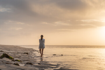 Woman at Sunset on the Beach