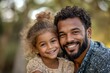© Phiranchaya Thatham - A father and daughter smile happily at the camera, their faces illuminated by the warmth of a sunny day.