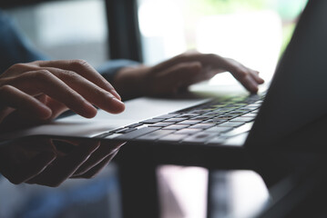 Poster - Closeup of business woman hand typing and working on laptop computer, searching the information, surfing the internet with digital tablet on office table, remote work, online job concept