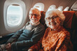 © SalenayaAlena - A smiling senior couple is enjoying their flight on a plane. Elderly people travelling for holidays.