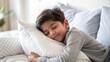 © N7 - Indian Child Resting - Close-up of an Indian child hugging a soft pillow in bed.