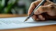 © Raitalinn - A closeup of a hand writes with a fountain pen on a paper document, capturing the essence of detail.