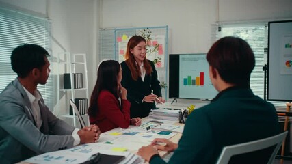 Aufkleber - Diverse team of businesspeople are having a productive meeting. Their asian manager is pointing at charts on a screen, showing positive growth