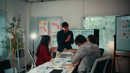 Poster - Three asian businesspeople celebrating a successful project. They are clapping their hands, happy with the results of their teamwork