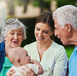 © peopleimages.com - Mother, baby and grandparents talking in nature, trust and love in relationship connection. Mama, grandma and grandpa for outdoor child development, speaking and boy for bonding in childhood park