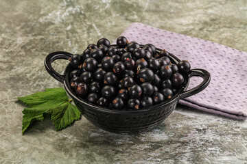 Ripe black currant in the bowl