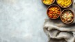 © Wish Craft Arts - Top view of four bowls with various food on gray background with copy space.