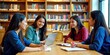 © Reubens Stock Photos - Diverse Group of Indian Students Studying and Collaborating in Modern Library