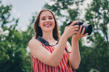 Wall Mural - Photo of cheerful adorable girl wear trendy clothes walk city center take picture summer weather outdoors