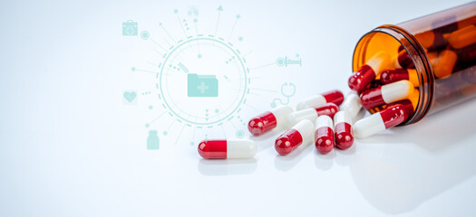 Canvas Print - Red white capsules spilling from plastic bottle on white background. Prescription drugs and pharmaceutical regulations. Safety standards and efficacy requirements in modern healthcare. Health policy.