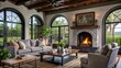 © Ouahdou - Rustic coffee table between sofa and chairs against fireplace and arched windows. Mediterranean modern cottage style home interior design of modern living room