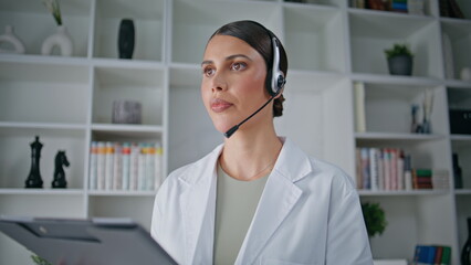 Professional doctor speaking headphones in hospital closeup. Healthcare expert