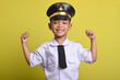 © Mulad Images - Little Asian boy Airplane pilot isolated on yellow background doing strong movement. Little boy dreams of becoming an airplane pilot.