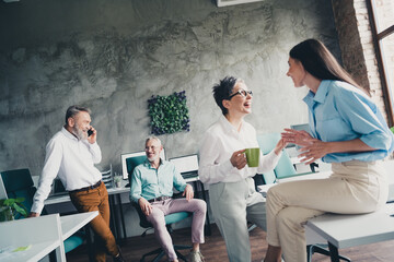 Sticker - Photo of four successful corporate colleagues speak phone laugh drink coffee loft interior office indoors