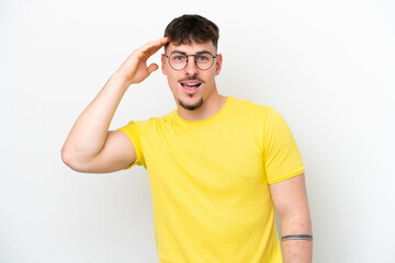 Wall Mural - Young caucasian handsome man isolated on white background has realized something and intending the solution