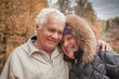© artmim - Laughing senior couple in autumn park, portrait